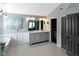 Well-lit bathroom showcasing a double vanity, modern light fixtures, and access to a spacious walk-in closet at 10155 Landis Blvd, Fortville, IN 46040