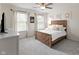 Cozy bedroom with large windows providing natural light, complemented by a ceiling fan and tasteful decor at 10155 Landis Blvd, Fortville, IN 46040