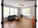 Bonus room featuring a futon, ceiling fan, and large windows for ample natural light at 10155 Landis Blvd, Fortville, IN 46040