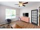 Bonus room with a ceiling fan, hard wood floors and a gray chair and dresser at 10155 Landis Blvd, Fortville, IN 46040