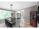Elegant dining room featuring a large window, dark wood table, and stylish china cabinet at 10155 Landis Blvd, Fortville, IN 46040