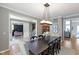 Open dining room showcasing a large table, stylish chandelier and seamless layout at 10155 Landis Blvd, Fortville, IN 46040