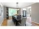 Dining room with a dark wood table and large window with floral patterned curtains at 10155 Landis Blvd, Fortville, IN 46040