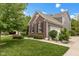 Charming two-story home featuring a brick facade, gray siding, and lush landscaping at 10155 Landis Blvd, Fortville, IN 46040