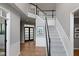 Spacious foyer featuring hardwood floors, staircase, and modern decor at 10155 Landis Blvd, Fortville, IN 46040