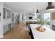 Open-concept layout featuring a kitchen island with seating, dining area, and staircase at 10155 Landis Blvd, Fortville, IN 46040