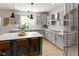 Modern kitchen with gray cabinets, stainless appliances, and a center island with bar seating at 10155 Landis Blvd, Fortville, IN 46040