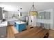Bright kitchen featuring gray cabinets, stainless appliances, large island, and wood flooring at 10155 Landis Blvd, Fortville, IN 46040