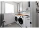 Laundry room with modern washer and dryer, wooden countertop, and white subway tile at 10155 Landis Blvd, Fortville, IN 46040