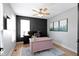 Bright home office with a pink desk, paneled accent wall, and modern decor at 10155 Landis Blvd, Fortville, IN 46040