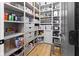 Organized walk-in pantry with wooden floors, gray shelving, drawers, and food storage at 10155 Landis Blvd, Fortville, IN 46040