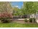 Relaxing outdoor patio area surrounded by lush landscaping and mature trees at 10155 Landis Blvd, Fortville, IN 46040