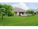 Lush backyard with a wooden deck, mature trees and well-maintained lawn at 10833 Tournament Ln, Indianapolis, IN 46229