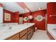 Bathroom with a double sink vanity, custom mirrors and soaking tub at 10833 Tournament Ln, Indianapolis, IN 46229