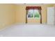 Neutral bedroom showcasing carpet flooring, a large window, and closet at 10833 Tournament Ln, Indianapolis, IN 46229