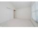 A neutral-colored bedroom featuring plush carpet and a large closet with sliding doors at 10833 Tournament Ln, Indianapolis, IN 46229