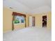 Bright primary bedroom featuring light yellow walls, and a closet at 10833 Tournament Ln, Indianapolis, IN 46229