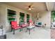 Relaxing covered patio with comfortable seating and a ceiling fan for outdoor enjoyment at 10833 Tournament Ln, Indianapolis, IN 46229