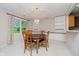 Dining room with a wooden table, built-in cabinets, and a hanging chandelier at 10833 Tournament Ln, Indianapolis, IN 46229