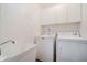 Functional laundry room with a utility sink and washer and dryer at 10833 Tournament Ln, Indianapolis, IN 46229