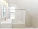 Bright bathroom featuring a tub-shower combination with white subway tile surround at 1115 N Keystone Ave, Indianapolis, IN 46201
