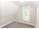 Cozy bedroom featuring neutral paint, plush gray carpet, and a bright window at 1115 N Keystone Ave, Indianapolis, IN 46201
