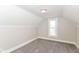 Bright bedroom with neutral paint, plush gray carpet, and a window at 1115 N Keystone Ave, Indianapolis, IN 46201