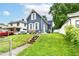 Exterior view of a two story home featuring a well-kept lawn and proximity to neighboring homes at 1115 N Keystone Ave, Indianapolis, IN 46201