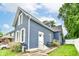 An angled exterior view showcases the home's design, including white trim, newer roof, and manicured yard at 1115 N Keystone Ave, Indianapolis, IN 46201
