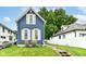 Charming blue two-story home featuring white trim, symmetrical windows, and a well-maintained lawn at 1115 N Keystone Ave, Indianapolis, IN 46201