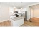 Modern kitchen with stainless steel appliances, white cabinets, granite countertops, and a kitchen island at 1115 N Keystone Ave, Indianapolis, IN 46201