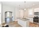 Well-lit kitchen featuring a granite island and an open layout with a view into another room at 1115 N Keystone Ave, Indianapolis, IN 46201