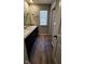 Bathroom featuring a double sink vanity, wood flooring, and a window with blinds at 11204 Sashing Way, Monrovia, IN 46157