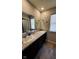 Bright bathroom featuring double sinks, dark cabinets, and modern finishes at 11204 Sashing Way, Monrovia, IN 46157