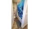 A small bathroom featuring shower tub with gray and white dolphin-themed curtain at 11204 Sashing Way, Monrovia, IN 46157