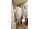 This is a bathroom with white toilet, gray walls and a shower tub at 11204 Sashing Way, Monrovia, IN 46157