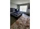 Bedroom with a large window, a bed with a patterned blanket, and a soft rug at 11204 Sashing Way, Monrovia, IN 46157