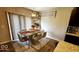 Dining room with a stone-top table, seating for six, modern chandelier, and a decorative rug at 11204 Sashing Way, Monrovia, IN 46157