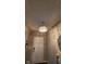 Foyer with chandelier, leading to front door, with decorative wall art and mirror at 11204 Sashing Way, Monrovia, IN 46157