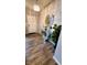 Welcoming foyer with wood floors, a decorative mirror, stylish table, and modern lighting at 11204 Sashing Way, Monrovia, IN 46157