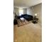 Open living room with a dark L-shaped couch, modern decor, and neutral carpet at 11204 Sashing Way, Monrovia, IN 46157