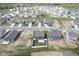 An aerial view of a well-planned community with neat landscaping and modern homes near a small lake at 1181 Galaxy Ln, Danville, IN 46122