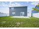 Large backyard with green lawn, white fence, and a patio accessible from the house at 1181 Galaxy Ln, Danville, IN 46122