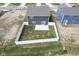 An aerial view shows a partially fenced backyard with a concrete patio and a small tree at 1181 Galaxy Ln, Danville, IN 46122