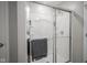 Updated bathroom with a shower that has a sliding glass door and a gray towel on the door handle at 1181 Galaxy Ln, Danville, IN 46122