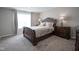 Bedroom with carpet and dark furniture, featuring side tables with lamps, and a large window at 1181 Galaxy Ln, Danville, IN 46122