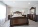Carpeted bedroom features dark furniture, side tables with lamps, and a large window at 1181 Galaxy Ln, Danville, IN 46122
