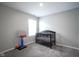 Bright bedroom with a small crib, a basketball hoop, and gray carpet at 1181 Galaxy Ln, Danville, IN 46122