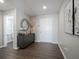 Stylish entryway with wood flooring, a decorative cabinet, and a round mirror enhancing the home's appeal at 1181 Galaxy Ln, Danville, IN 46122
