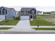 This two-story home features an attached garage, a large driveway, and a freshly sodded lawn at 1181 Galaxy Ln, Danville, IN 46122